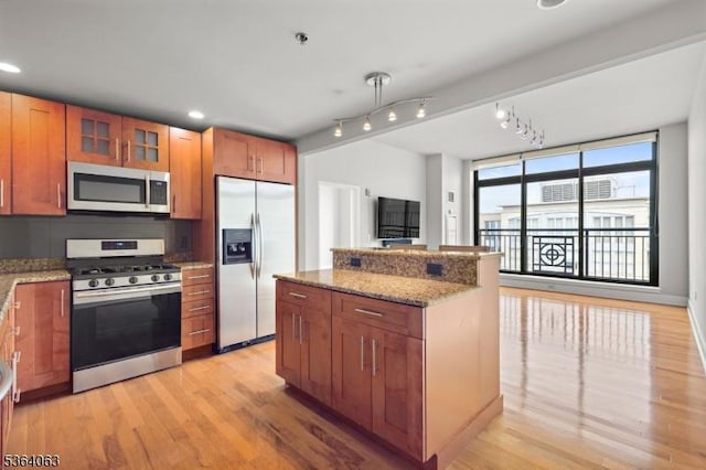 1025 Maxwell Ln Unit 1209, Hoboken City, NJ 07030 - kitchen featuring stainless steel appliances, light wood-style floors, light stone counters, a kitchen island, and recessed lighting