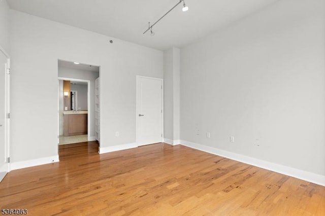 1025 Maxwell Ln Unit 1209, Hoboken City, NJ 07030 - unfurnished bedroom with light wood finished floors and rail lighting