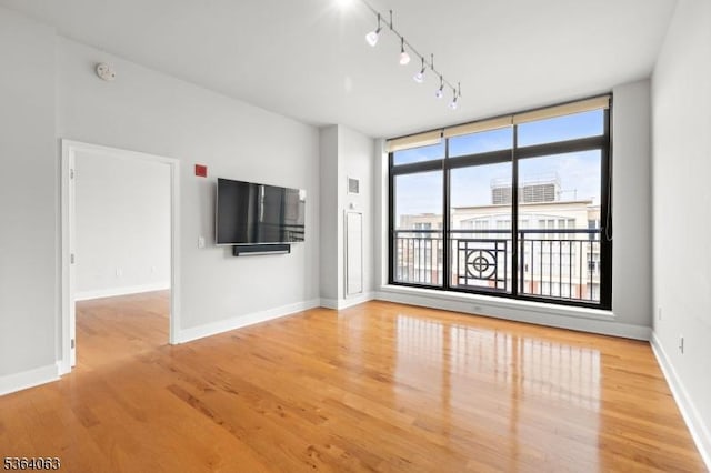 1025 Maxwell Ln Unit 1209, Hoboken City, NJ 07030 - unfurnished living room featuring wood finished floors and rail lighting