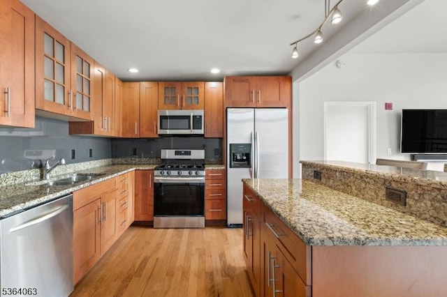 1025 Maxwell Ln Unit 1209, Hoboken City, NJ 07030 - kitchen with appliances with stainless steel finishes, light wood-style floors, glass insert cabinets, light stone countertops, and recessed lighting
