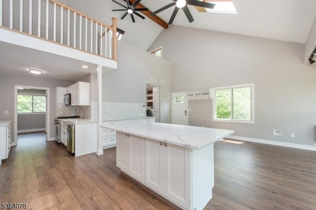 2 Falkenstein Dr Unit 10, Vernon Twp, NJ 07462 - kitchen featuring ceiling fan, high vaulted ceiling, decorative backsplash, range, and beam ceiling