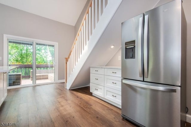 2 Falkenstein Dr Unit 10, Vernon Twp, NJ 07462 - kitchen with stainless steel fridge with ice dispenser, wood finished floors, white cabinetry, vaulted ceiling, and light countertops