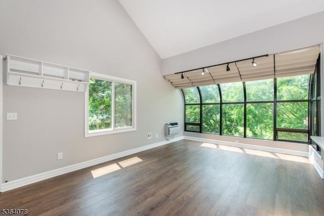 2 Falkenstein Dr Unit 10, Vernon Twp, NJ 07462 - unfurnished living room with plenty of natural light, high vaulted ceiling, dark wood-style floors, a wall mounted AC, and rail lighting
