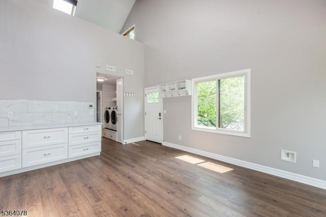 2 Falkenstein Dr Unit 10, Vernon Twp, NJ 07462 - unfurnished living room with washer and clothes dryer, high vaulted ceiling, and dark wood-type flooring