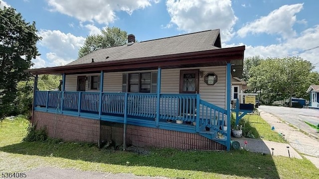 3 Hann Ter, Washington Boro, NJ 07882 - view of front facade with covered porch, a front yard, a chimney, and roof with shingles