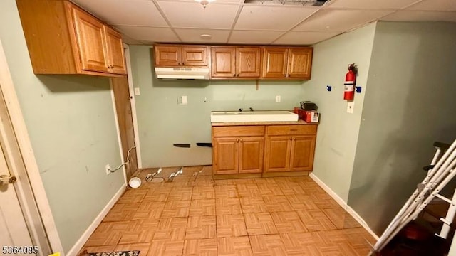 3 Hann Ter, Washington Boro, NJ 07882 - kitchen with under cabinet range hood, a paneled ceiling, brown cabinets, and light countertops