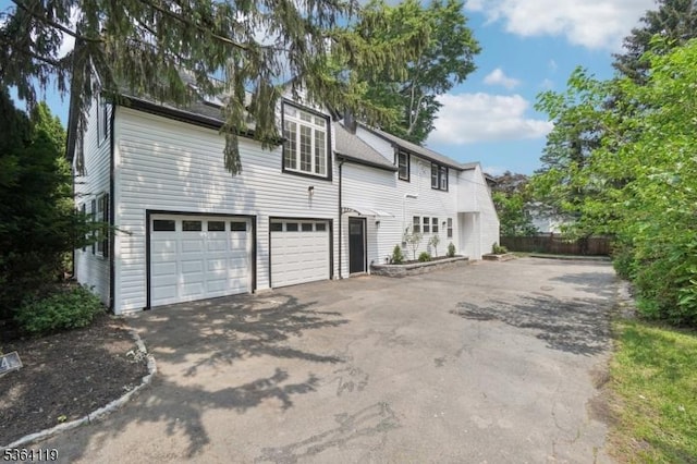 24 Tuers Pl, Montclair Twp, NJ 07043 - view of front of house with asphalt driveway and a garage