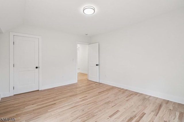 24 Tuers Pl, Montclair Twp, NJ 07043 - spare room featuring light wood-style flooring and vaulted ceiling