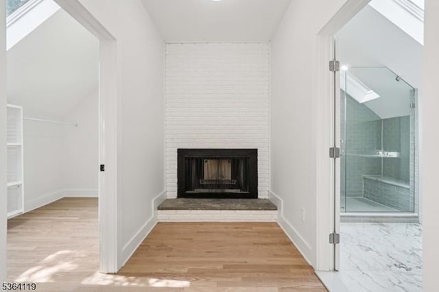 24 Tuers Pl, Montclair Twp, NJ 07043 - detailed view of a fireplace, wood finished floors, and a skylight