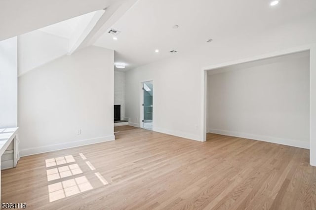 24 Tuers Pl, Montclair Twp, NJ 07043 - unfurnished living room with a brick fireplace, light wood-type flooring, and recessed lighting