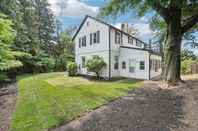 24 Tuers Pl, Montclair Twp, NJ 07043 - view of home's exterior with a chimney and a yard