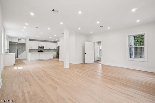 24 Tuers Pl, Montclair Twp, NJ 07043 - unfurnished living room featuring light wood finished floors and recessed lighting