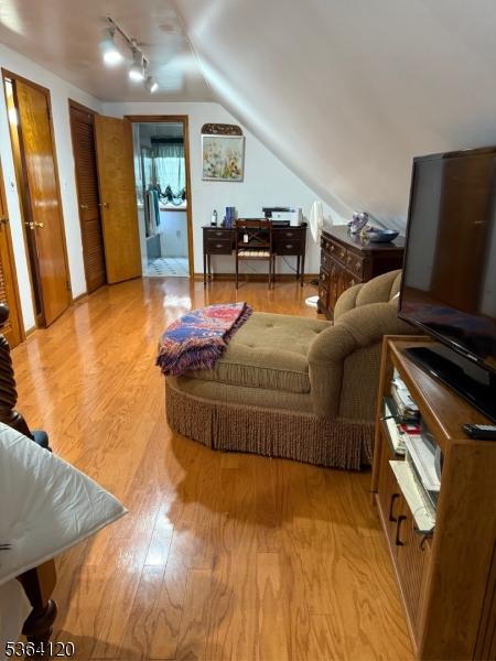 1221 Grant Ave, Plainfield City, NJ 07060 - living room with light wood-type flooring, rail lighting, and lofted ceiling
