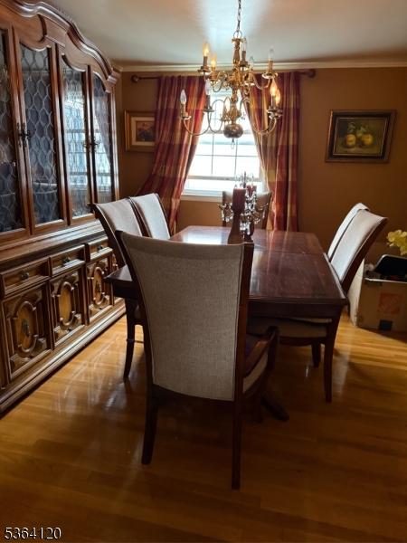 1221 Grant Ave, Plainfield City, NJ 07060 - dining space with a chandelier, wood finished floors, and crown molding