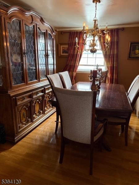 1221 Grant Ave, Plainfield City, NJ 07060 - dining area with a chandelier and light wood finished floors