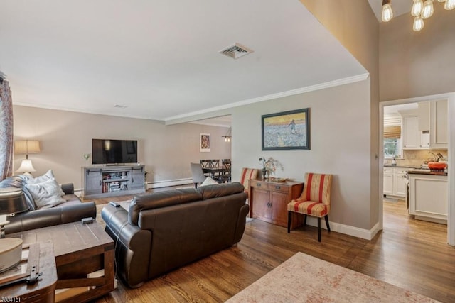 198 Pittsford Way, New Providence Boro, NJ 07974 - living area featuring ornamental molding, wood finished floors, a baseboard radiator, and a chandelier