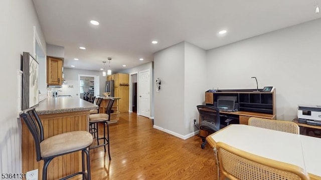 505 Sheppard Ct, Hillsborough Twp, NJ 08844 - kitchen featuring light wood-style flooring, recessed lighting, a kitchen bar, decorative backsplash, and hanging light fixtures
