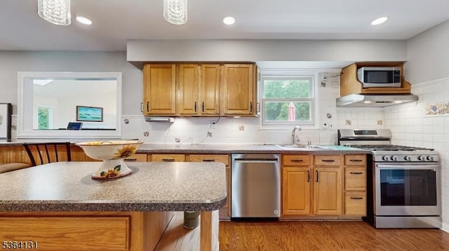 505 Sheppard Ct, Hillsborough Twp, NJ 08844 - kitchen with stainless steel appliances, light wood finished floors, extractor fan, tasteful backsplash, and brown cabinetry