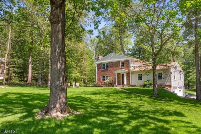 37 Dogwood Dr, Chester Twp, NJ 07930 - greek revival inspired property featuring a front yard, a garage, a chimney, and brick siding