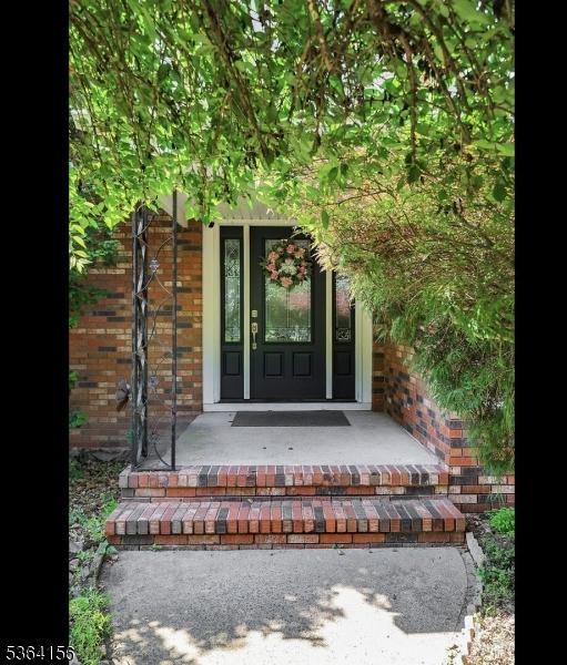 165 Rock Rd W, Green Brook Twp, NJ 08812 - doorway to property featuring brick siding