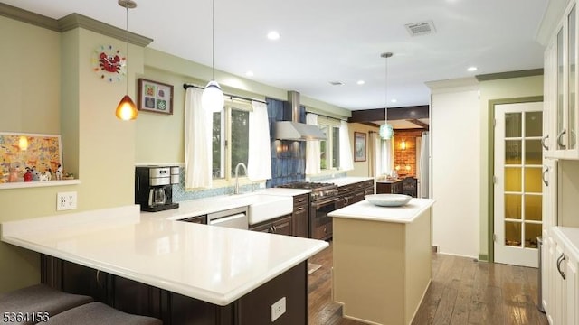 165 Rock Rd W, Green Brook Twp, NJ 08812 - kitchen with wall chimney range hood, high end stainless steel range, a center island, light countertops, and a peninsula
