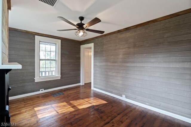 132 Axford Ave, Oxford Twp, NJ 07863 - unfurnished room with baseboards, a ceiling fan, hardwood / wood-style flooring, and wood walls