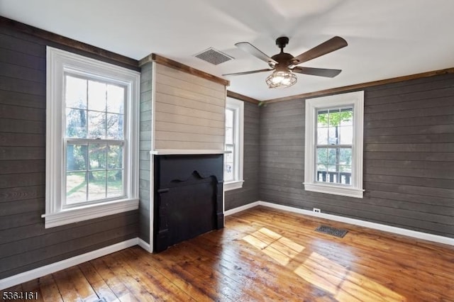 132 Axford Ave, Oxford Twp, NJ 07863 - unfurnished living room featuring baseboards, wood-type flooring, ceiling fan, and wood walls