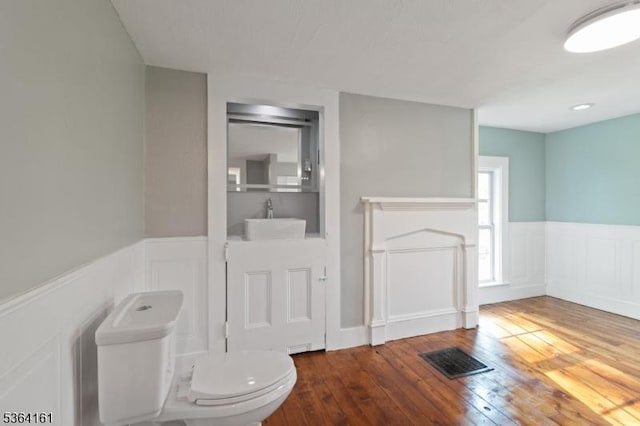 132 Axford Ave, Oxford Twp, NJ 07863 - bathroom with a sink, a wainscoted wall, hardwood / wood-style flooring, toilet, and a decorative wall