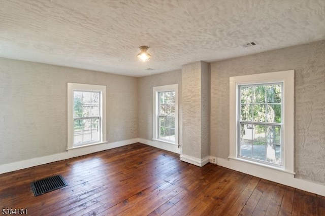 132 Axford Ave, Oxford Twp, NJ 07863 - empty room featuring dark wood-type flooring, plenty of natural light, baseboards, and a textured ceiling