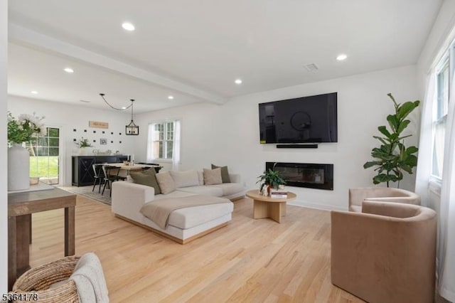 29 Tennis Rd, Jefferson Twp, NJ 07849 - living room featuring a glass covered fireplace, light wood finished floors, recessed lighting, plenty of natural light, and beamed ceiling