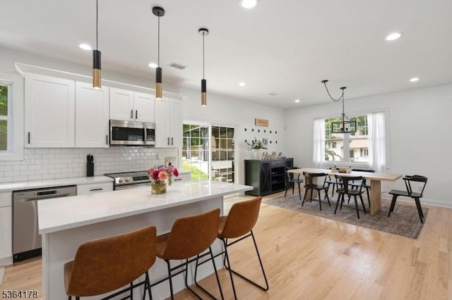 29 Tennis Rd, Jefferson Twp, NJ 07849 - kitchen with appliances with stainless steel finishes, backsplash, plenty of natural light, white cabinetry, and recessed lighting