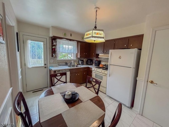 23 Bogle Ave, North Arlington Boro, NJ 07031 - kitchen with white appliances, under cabinet range hood, light countertops, tasteful backsplash, and pendant lighting