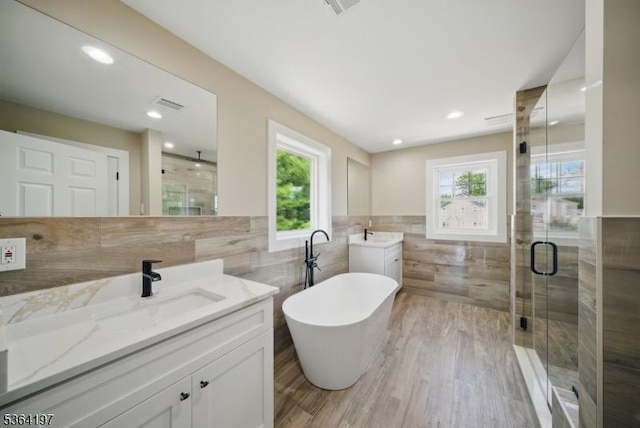 181 Randolph Ave, Mine Hill Twp, NJ 07803 - full bath with tile walls, a stall shower, two vanities, a soaking tub, and wood finished floors
