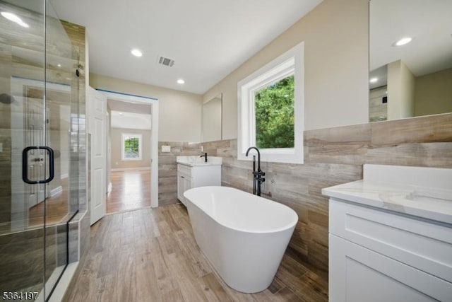 181 Randolph Ave, Mine Hill Twp, NJ 07803 - bathroom with tile walls, vanity, a shower stall, plenty of natural light, and a freestanding bath