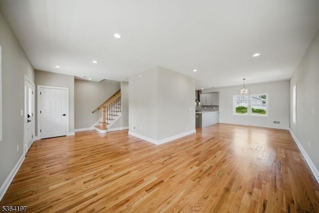 181 Randolph Ave, Mine Hill Twp, NJ 07803 - unfurnished living room with light wood-style floors, stairway, recessed lighting, and a chandelier