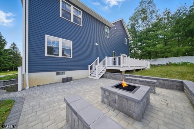 181 Randolph Ave, Mine Hill Twp, NJ 07803 - back of property featuring a fire pit, a wooden deck, and a patio area