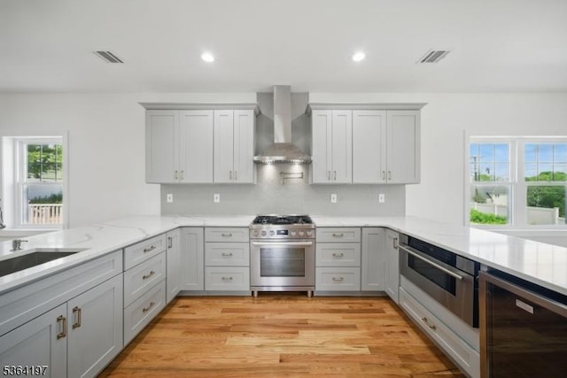 181 Randolph Ave, Mine Hill Twp, NJ 07803 - kitchen featuring appliances with stainless steel finishes, wall chimney range hood, a peninsula, beverage cooler, and recessed lighting