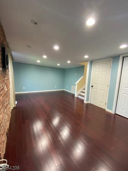 9 Village Way Unit B5, Vernon Twp, NJ 07462 - finished basement featuring stairway, wood-type flooring, and a fireplace