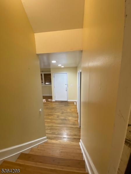 9 Village Way Unit B5, Vernon Twp, NJ 07462 - hall featuring wood finished floors and a high ceiling