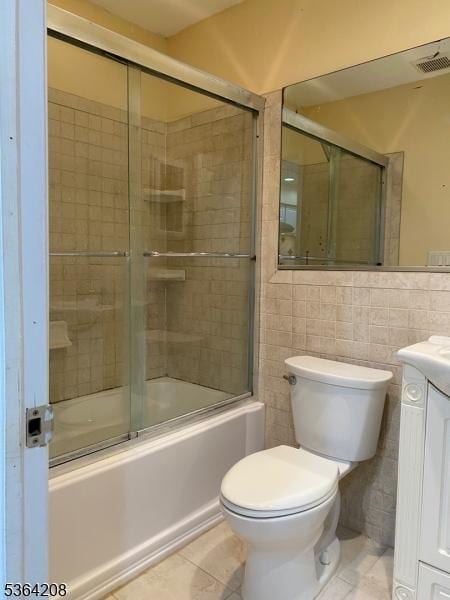 9 Village Way Unit B5, Vernon Twp, NJ 07462 - full bathroom with vanity, bath / shower combo with glass door, tile patterned floors, and tile walls