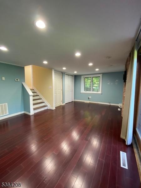 9 Village Way Unit B5, Vernon Twp, NJ 07462 - unfurnished living room featuring stairs, wood finished floors, and recessed lighting