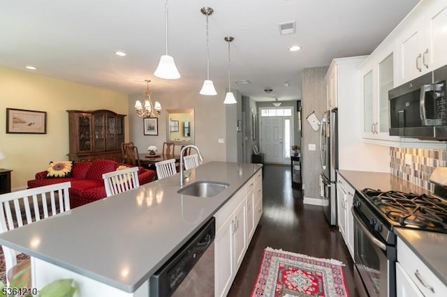 3 Indigo Rd, Allamuchy Twp, NJ 07840 - kitchen with appliances with stainless steel finishes, a chandelier, an island with sink, dark wood finished floors, and white cabinets