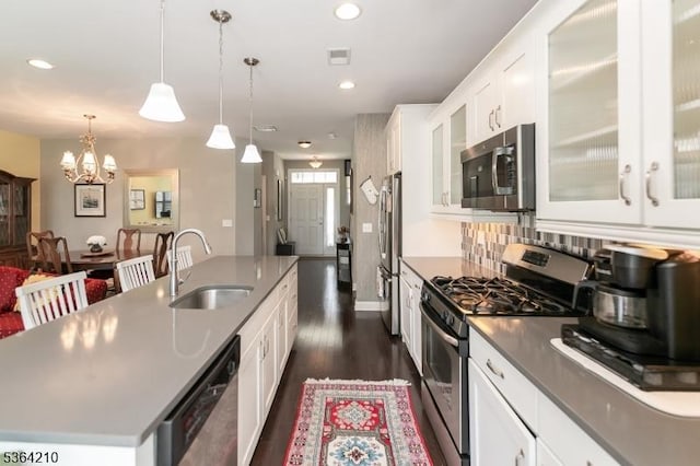 3 Indigo Rd, Allamuchy Twp, NJ 07840 - kitchen featuring stainless steel appliances, a chandelier, dark wood finished floors, a center island with sink, and white cabinets