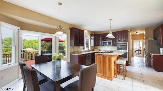 74 Oxford Pl, Hillsborough Twp, NJ 08844 - kitchen featuring stainless steel appliances, light countertops, backsplash, a kitchen island, and light tile patterned flooring
