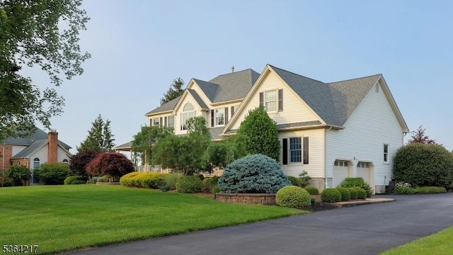 74 Oxford Pl, Hillsborough Twp, NJ 08844 - view of front of property with an attached garage, a front lawn, and asphalt driveway