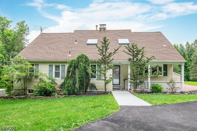 25 Mordaunt Rd, Vernon Twp, NJ 07462 - view of front of home featuring a front lawn, a chimney, covered porch, and roof with shingles