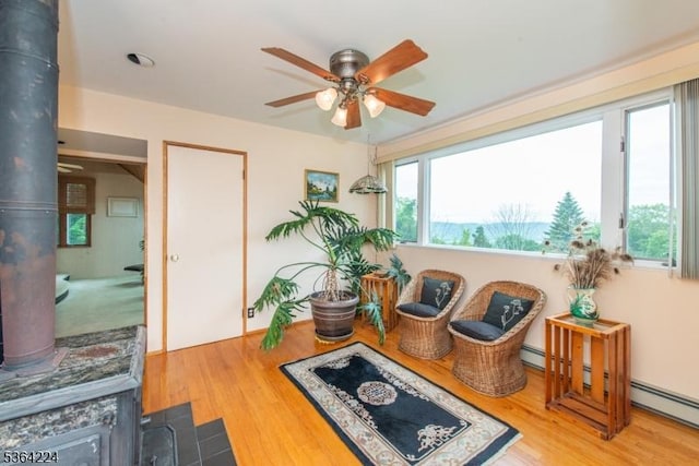25 Mordaunt Rd, Vernon Twp, NJ 07462 - living area featuring a wood stove, a ceiling fan, and wood finished floors
