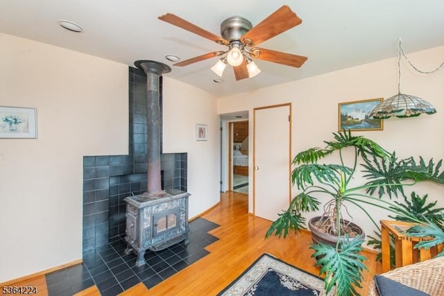 25 Mordaunt Rd, Vernon Twp, NJ 07462 - living room featuring a wood stove, wood finished floors, and a ceiling fan