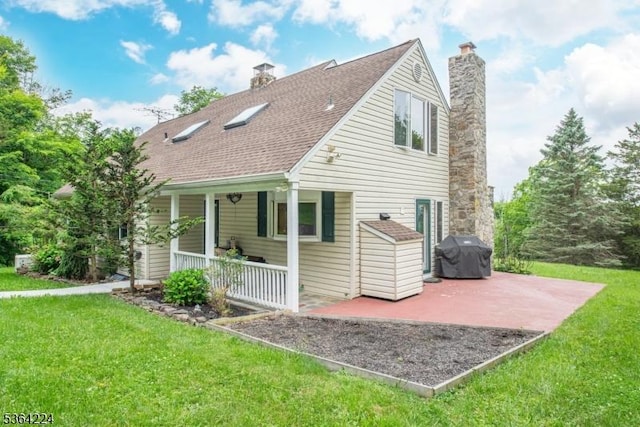 25 Mordaunt Rd, Vernon Twp, NJ 07462 - rear view of house with a chimney, a yard, and covered porch