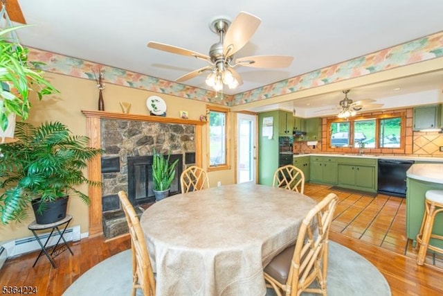 25 Mordaunt Rd, Vernon Twp, NJ 07462 - dining room with ceiling fan, a fireplace, and a baseboard radiator